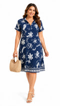 Women's navy floral print woven dress with V-neck and decorative border hem, front view model
