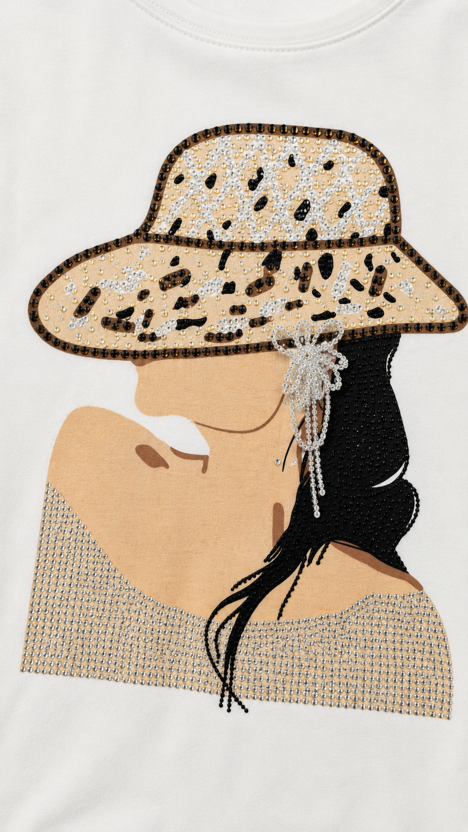Close-up of rhinestone woman portrait with wide-brimmed hat on white t-shirt showing crystal detail