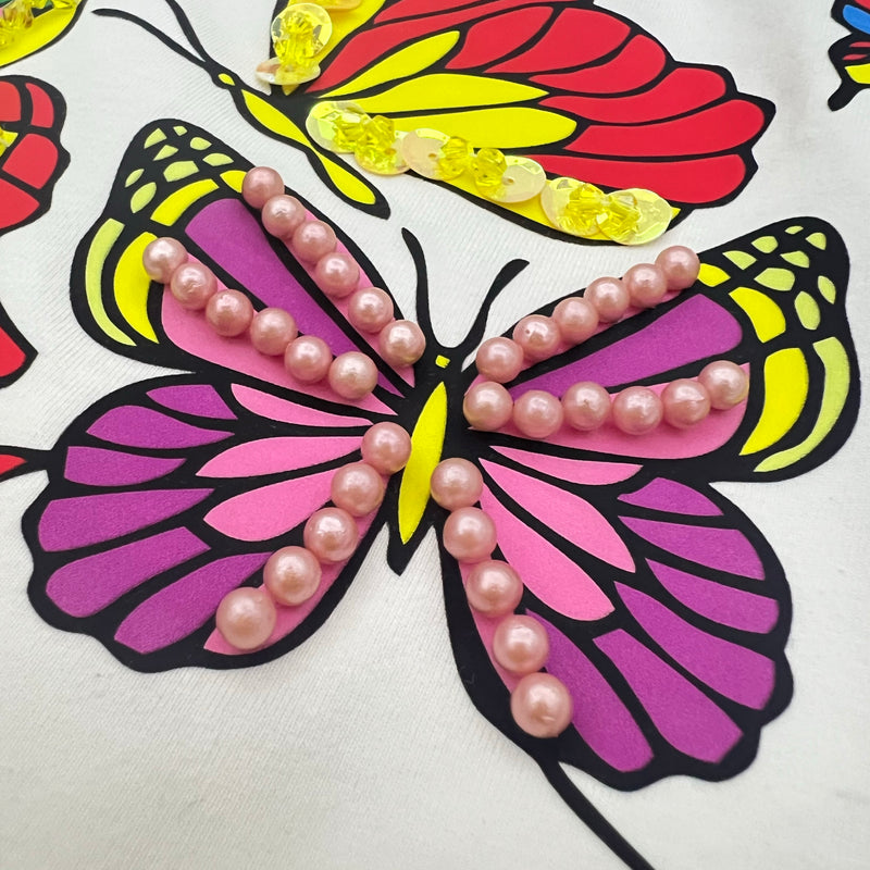 Hand beading craftsmanship detail on custom T-shirt
