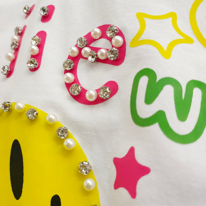 Hand beading craftsmanship detail on custom T-shirt