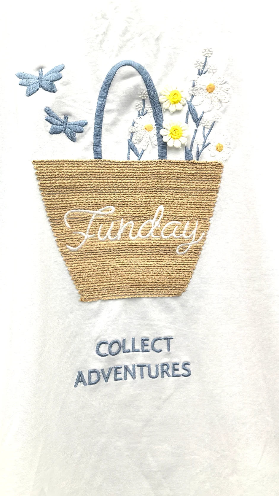 Close-up of embroidered ice cream cone cutwork detail on t-shirt