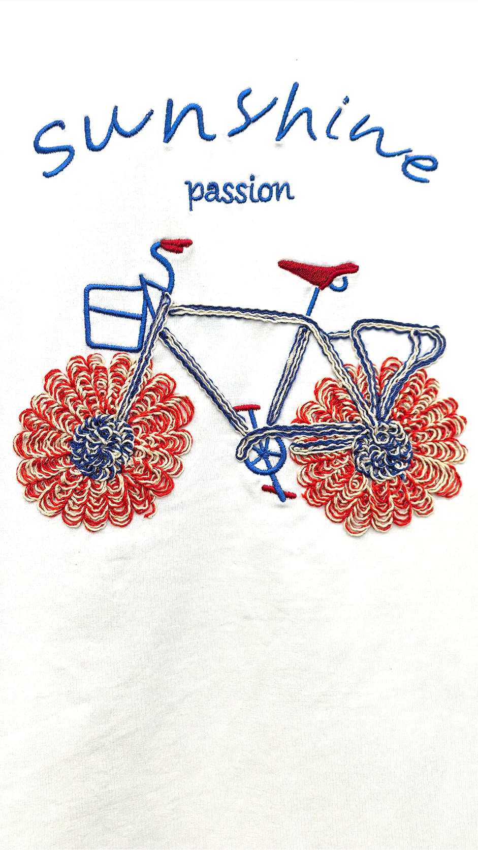 Close-up of embroidered floral bicycle and Sunshine cutwork detail on t-shirt