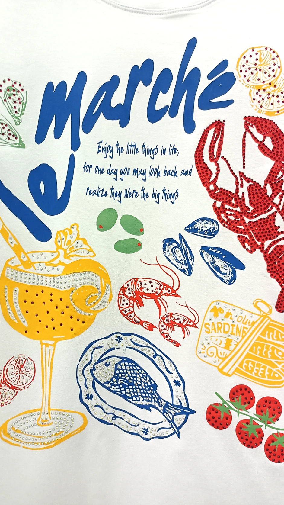 Close-up of marché French market graphic print with lobster lemon and seafood illustration detail