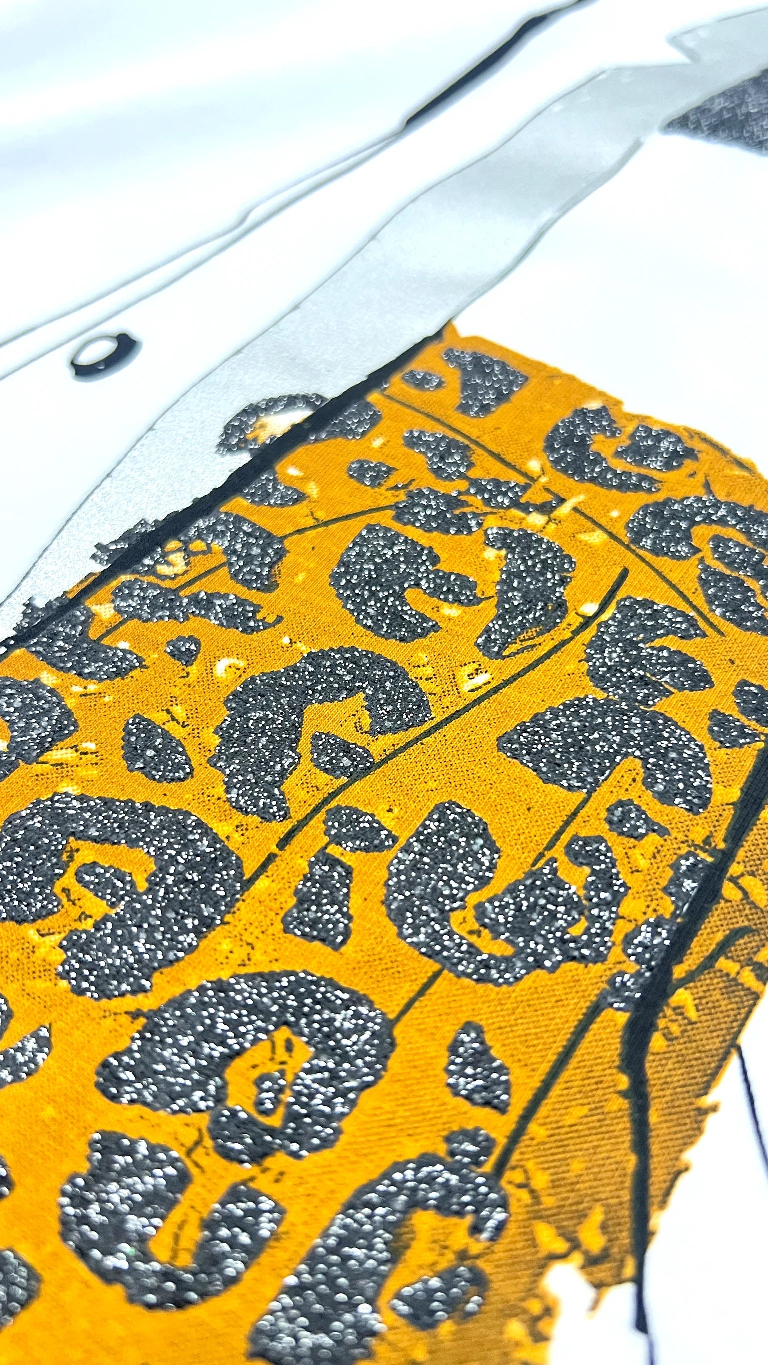 Close-up of cartoon character print and repeating pattern detail on t-shirt
